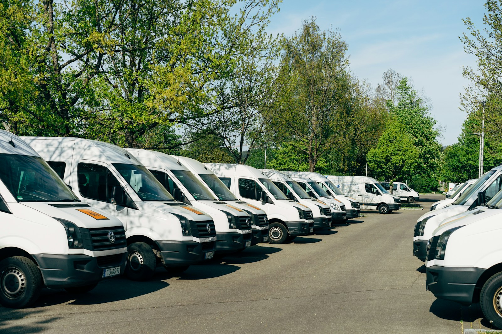 Fleet of commercial vans parked in a business lot